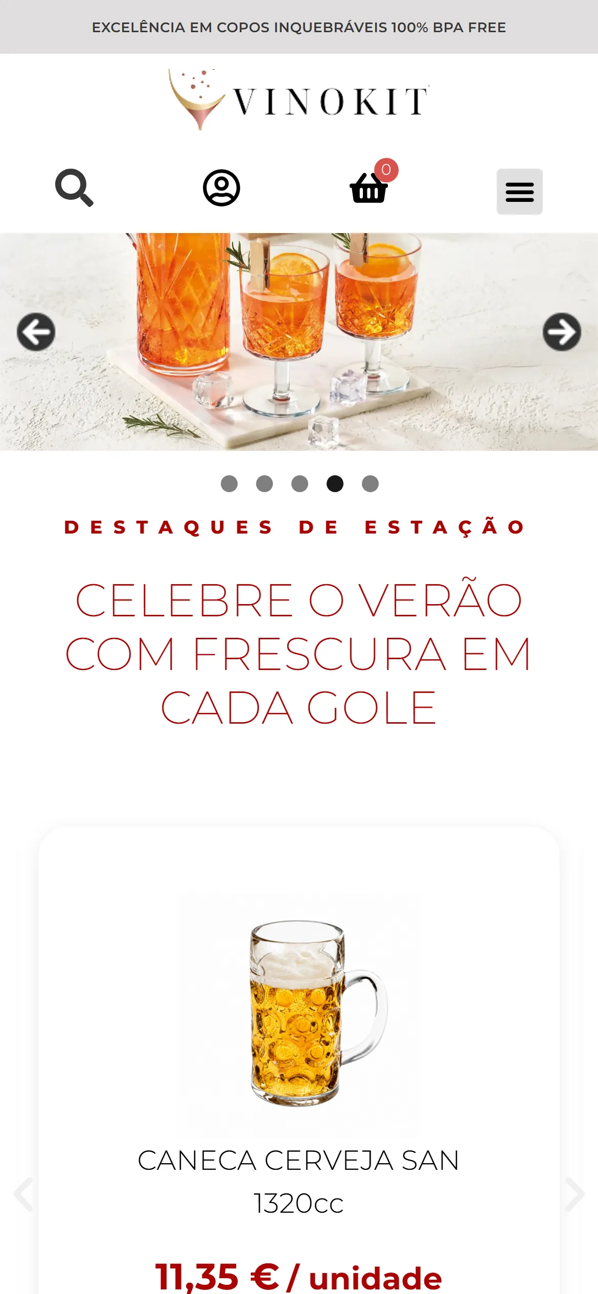 Página inicial da Vinokit em telefone: a barra Excelência em copos inquebráveis 100% BPA free, o logótipo, os ícones de pesquisa, conta e cesto, o botão de menu, a fotografia de um jarro e dois copos lapidados com bebida cor de laranja sobre uma tábua de mármore e o início da secção Destaques de estação, com o título Celebre o verão com frescura em cada gole e o cartão da Caneca Cerveja San 1320cc.